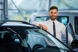 handsome-man-posing-near-luxury-car-showroom_7502-9569